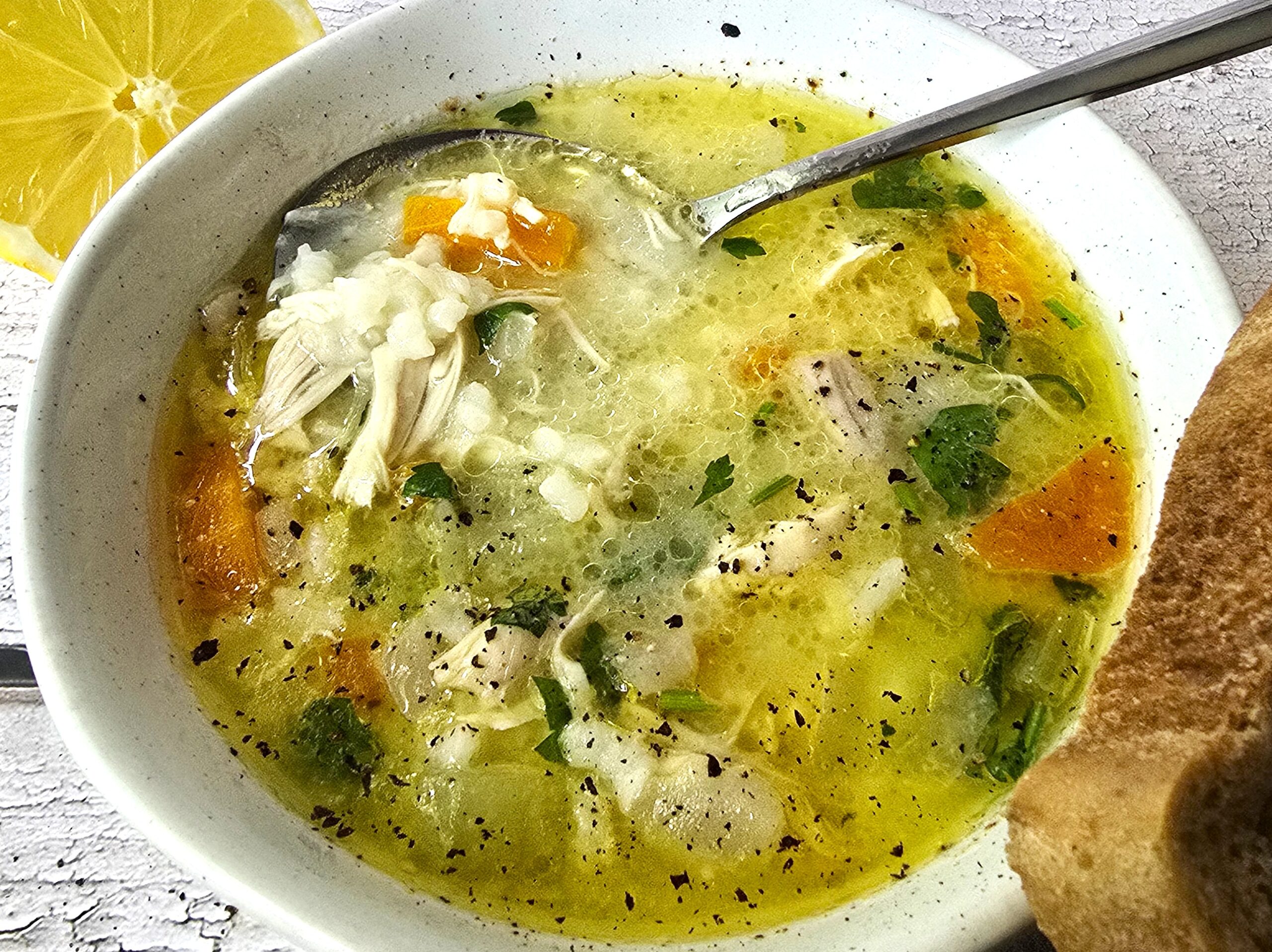 Hearty chicken soup served with gluten-free bread on rustic linen, Balkan-style