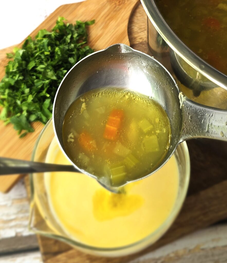 the process of adding a warm soup to egg-yolks-yoghurt sauce for tempering