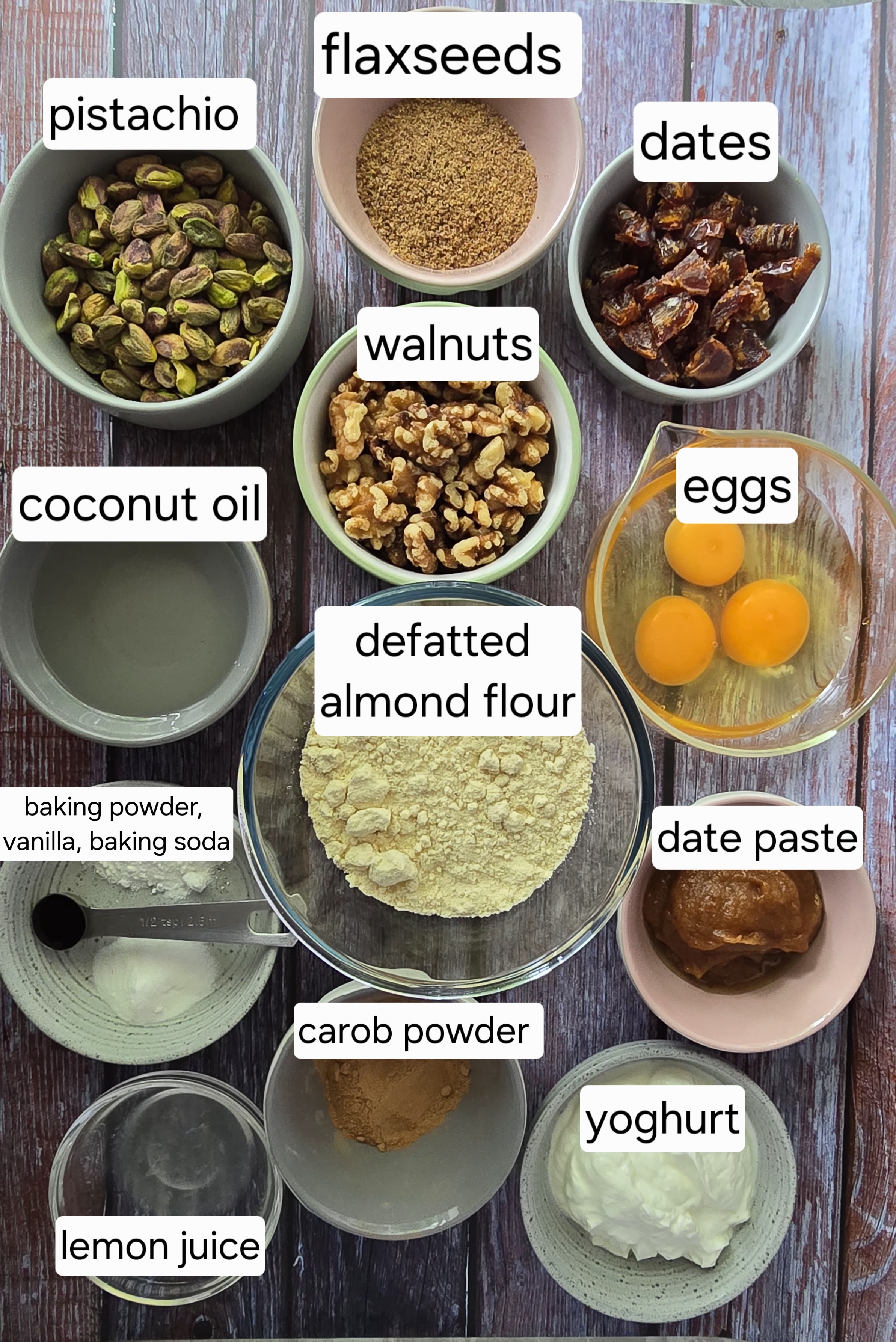 Ingredients for gluten-free pistachio walnut cake: eggs, nuts, date paste, coconut oil, carob, yoghurt, defatted almond flour, and flaxseed.