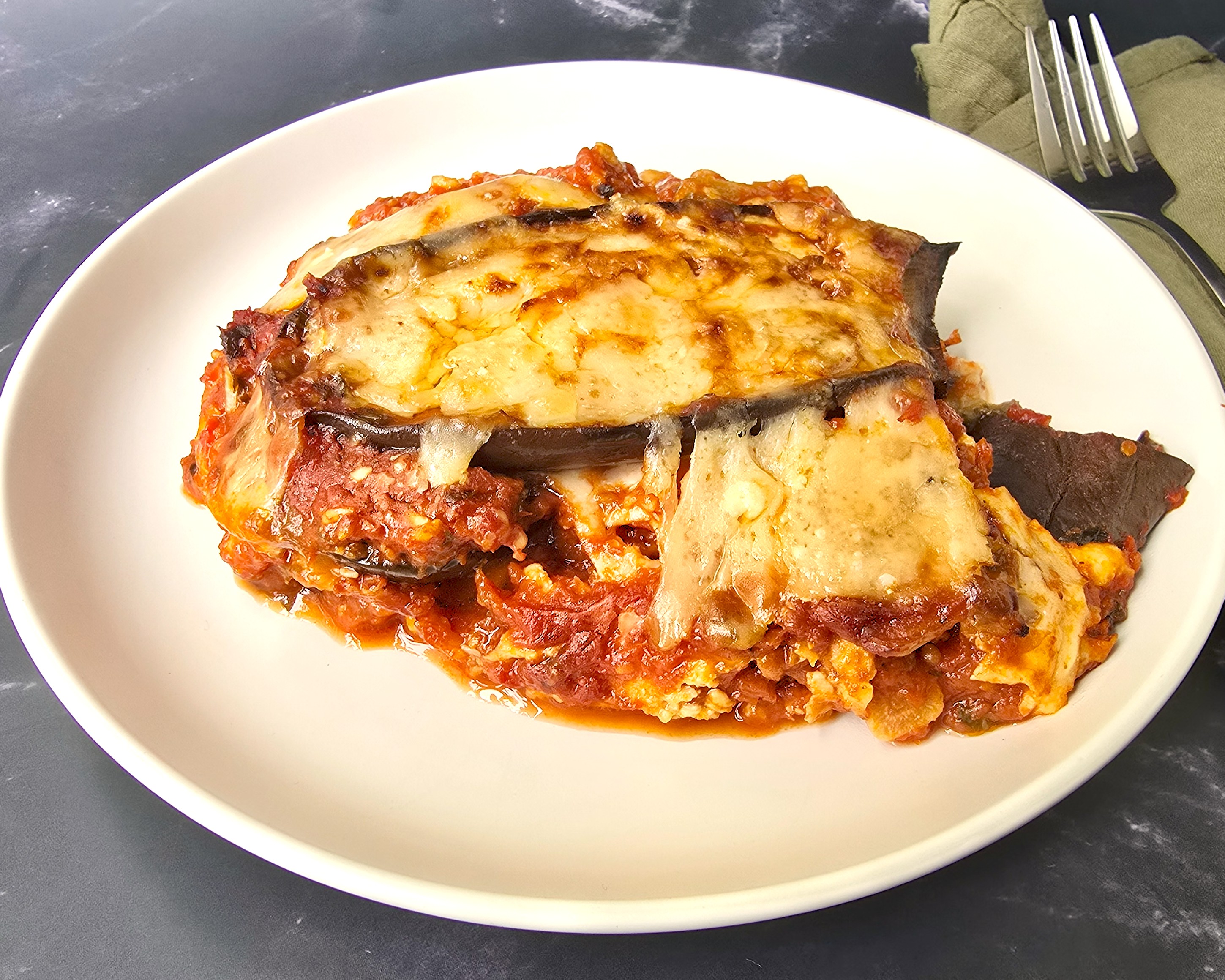 aubergine parmigiana in  a white plate