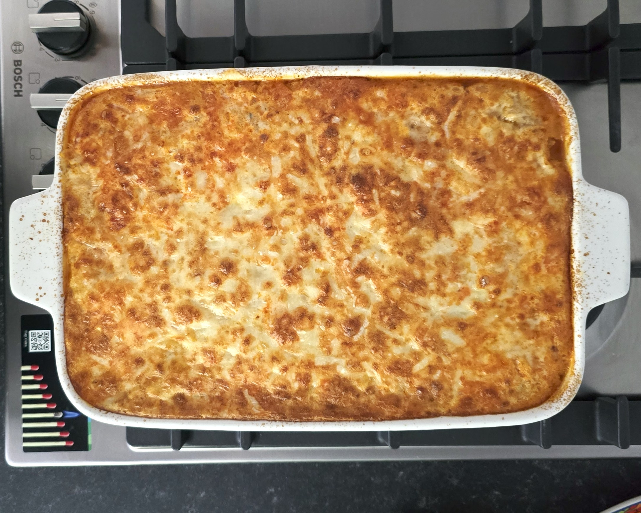 baked Bulgarian style moussaka in a white ceramic baking dish