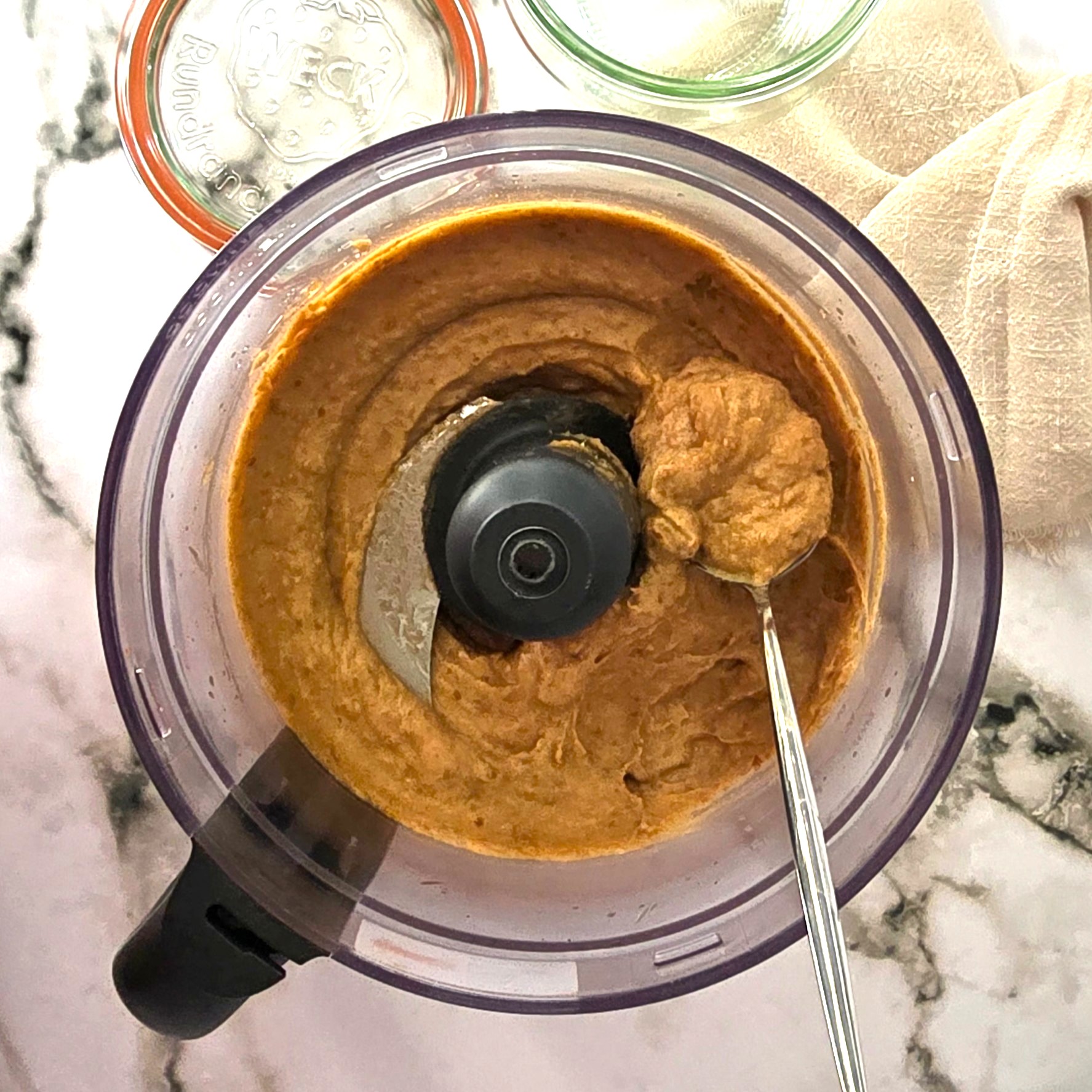 blended date paste ready to be stored in a jar