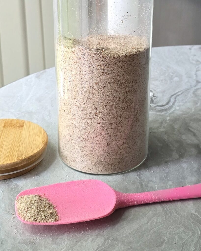 A blended dry almond pulp in a storage container