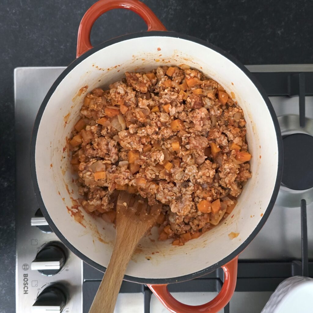 a pot with vegetables sauteed with minced meat