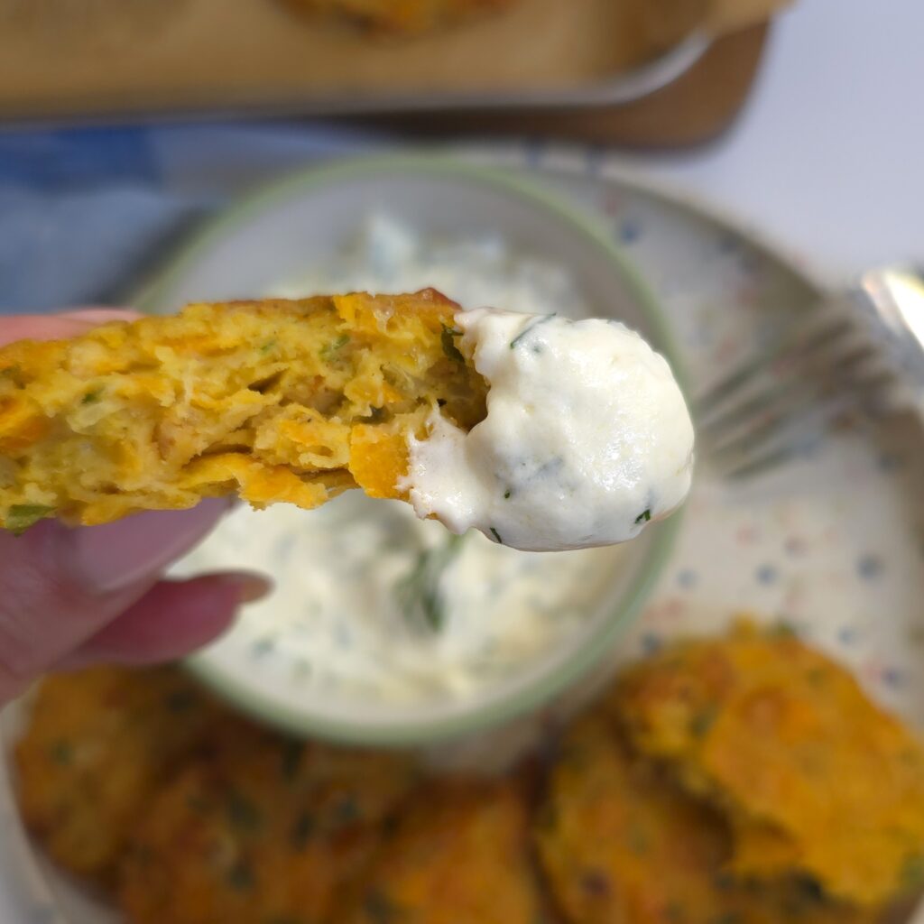 a close look of chickpea patty topped in a yoghurt garlic dip