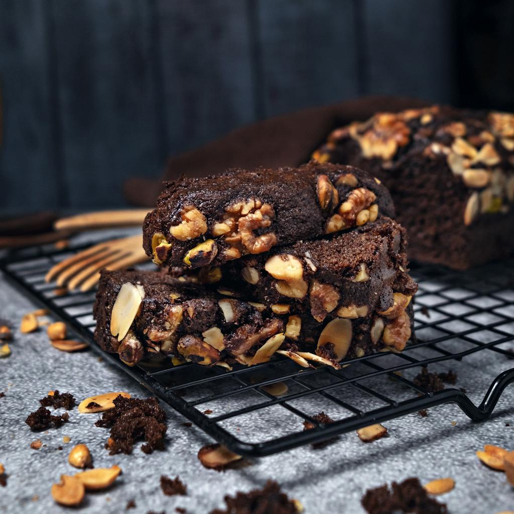 Close-up of homemade gluten-free chocolate brownies with nuts on a cooling rack.