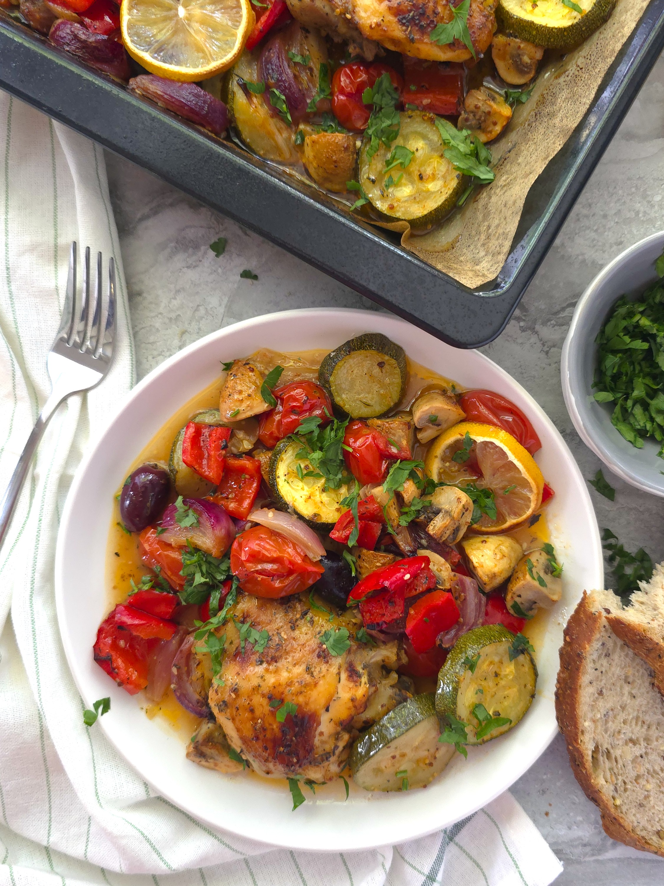 Greek chicken sheet pan portion in a white plate