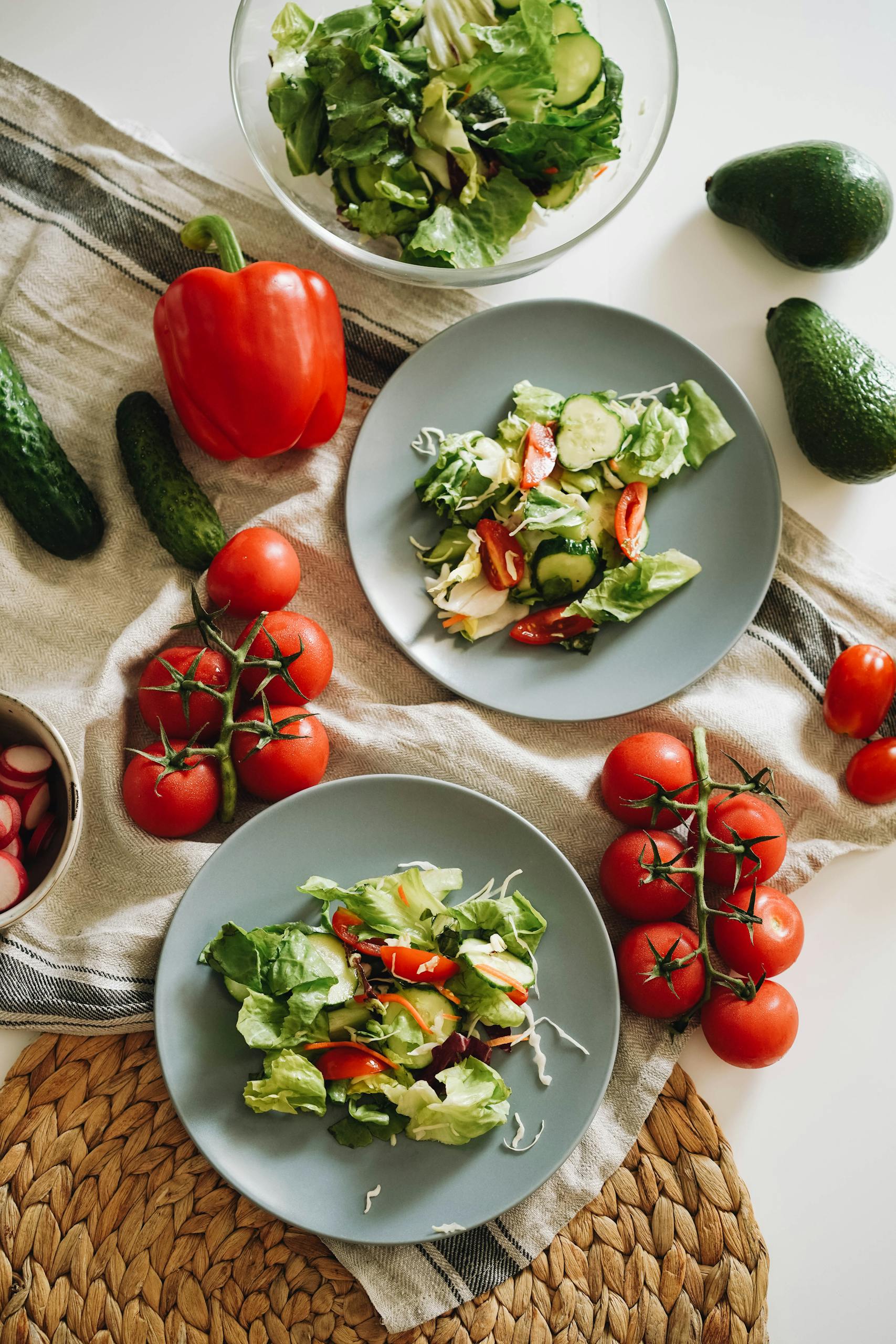 Fresh Bulgarian salad with tomatoes, cucumber, and peppers on grey plates – wholesome gluten-free Balkan-inspired dish